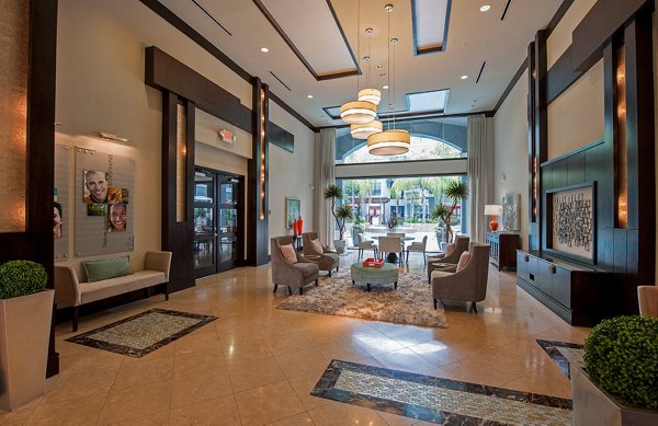 Game room with billiards table and lounge area at Monaco at Main Apartments, a luxury community offering entertainment and relaxation spaces