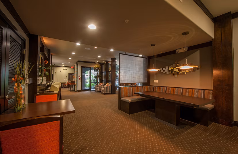 Clubhouse featuring modern decor and cozy seating at Monaco at Main luxury apartments in a vibrant community