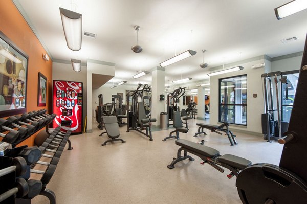 State-of-the-art fitness center at Monaco at Main Apartments with cardio machines and free weights