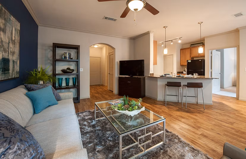 Elegant living room with modern furnishings at Monaco at Main Apartments