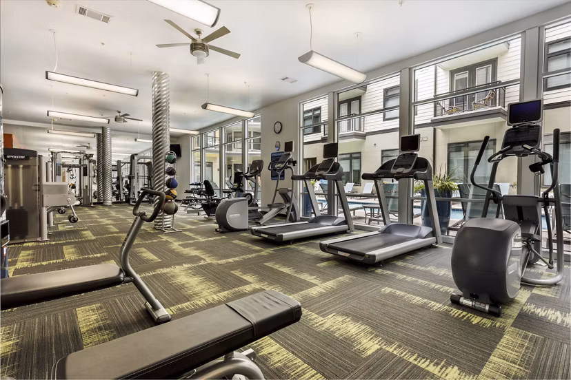 Modern fitness center with state-of-the-art equipment at Haus 5350 Apartments, providing a luxurious workout experience for residents