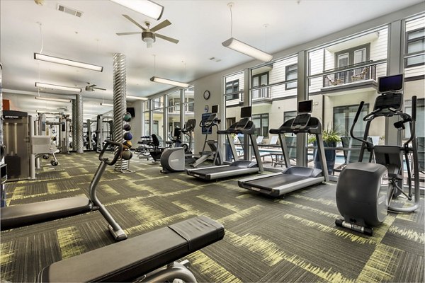 Modern fitness center with state-of-the-art equipment at Haus 5350 Apartments, providing a luxurious workout experience for residents