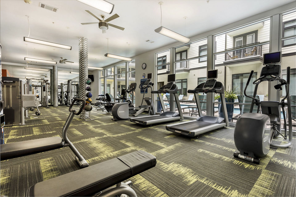 Modern fitness center with state-of-the-art equipment at Haus 5350 Apartments, providing a luxurious workout experience for residents