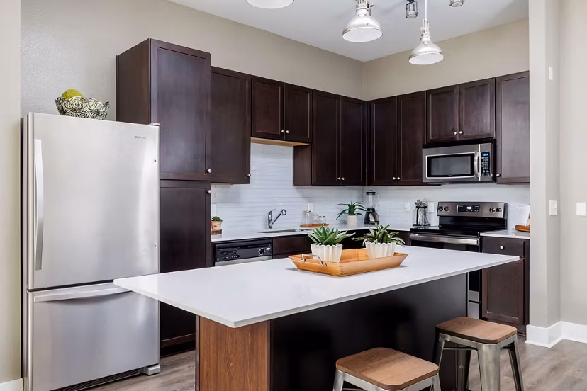 Modern kitchen with stainless steel appliances and island counter at Haus 5350 Apartments