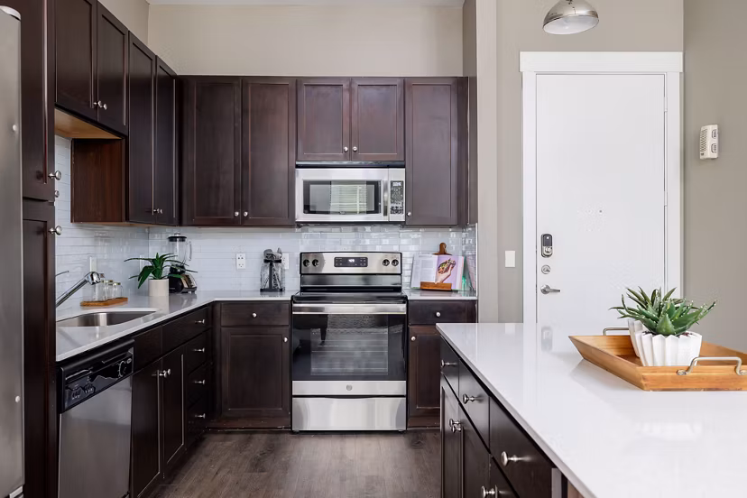 Haus 5350 Apartments: Modern kitchen with stainless steel appliances and sleek countertops in luxury apartment