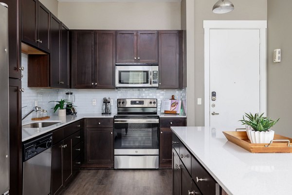 Haus 5350 Apartments: Modern kitchen with stainless steel appliances and sleek countertops in luxury apartment