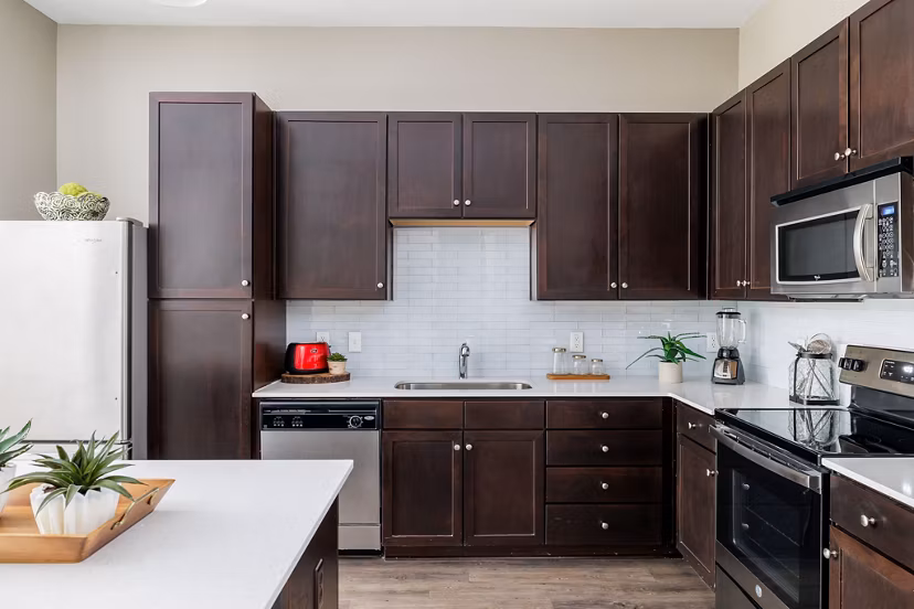 Modern kitchen with stainless steel appliances at Haus 5350 Apartments luxury apartment community