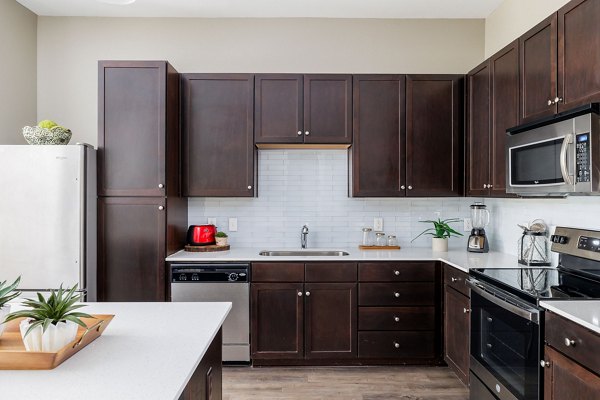 Modern kitchen with stainless steel appliances at Haus 5350 Apartments luxury apartment community