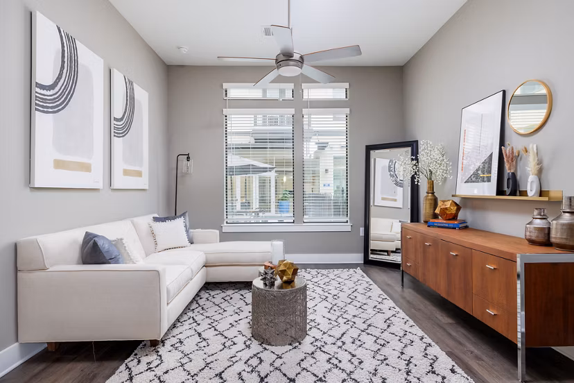 Spacious living room with modern decor and natural light in Haus 5350 Apartments