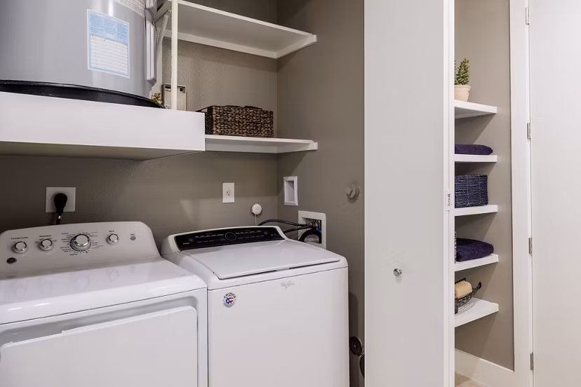 Laundry room featuring modern appliances at Drexler Townhomes at Holbrook Farms
