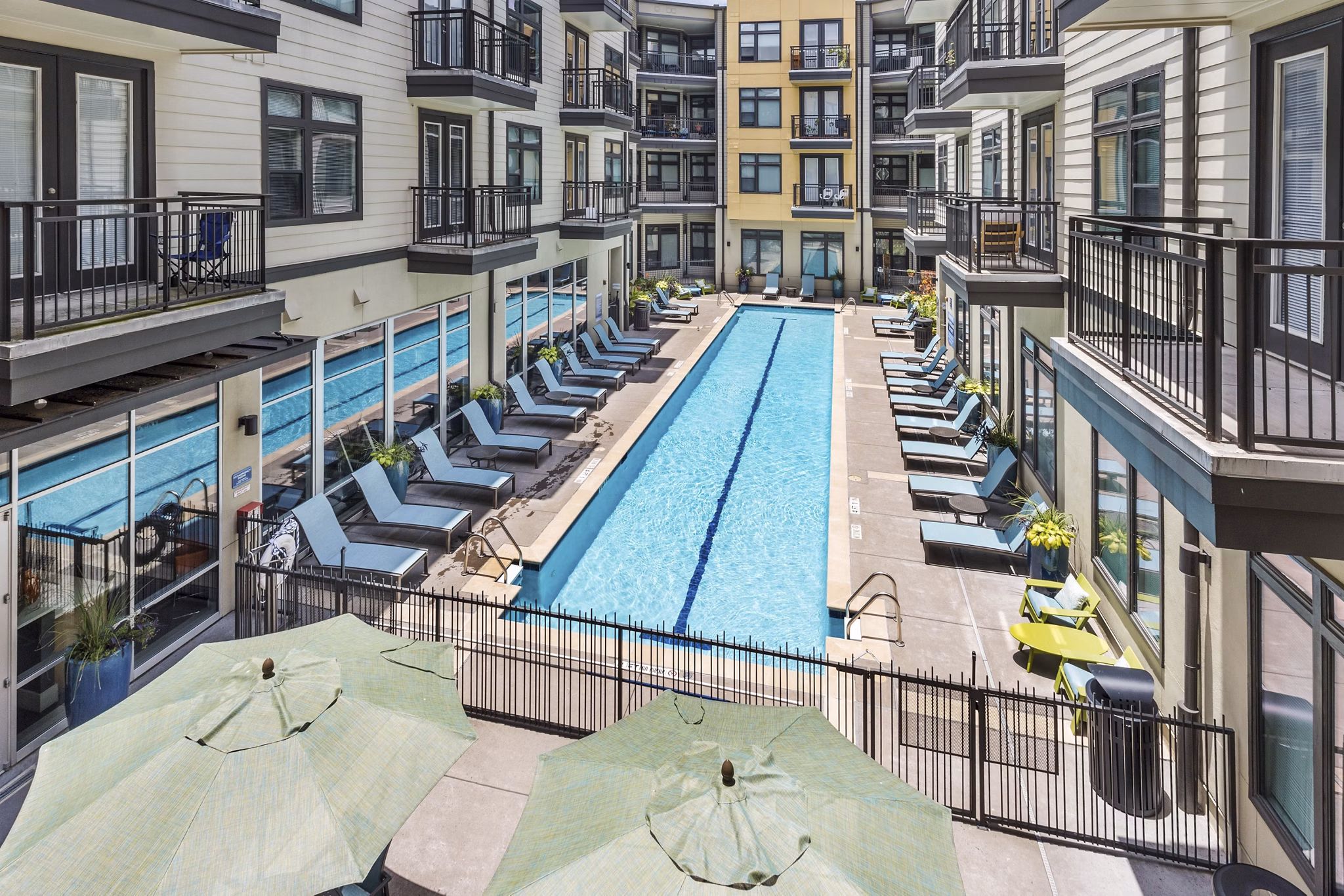 Haus 5350 Apartments: Luxury pool area with modern design and seating options at Greystar's high-end property
