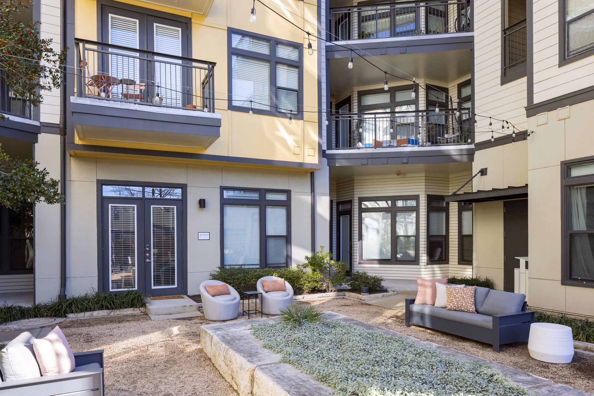 Courtyard featuring lush greenery at Haus 5350 Apartments, a luxury Greystar community in a serene setting