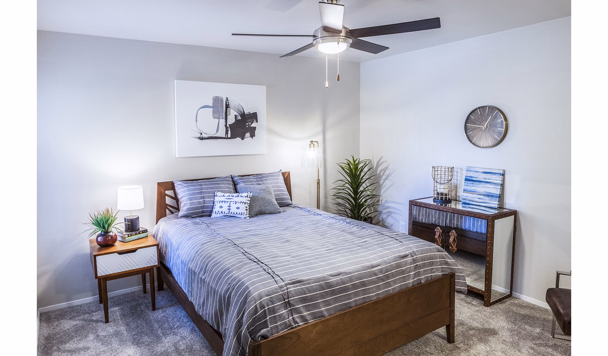 Chic bedroom with modern decor and large windows at OTTAVO Apartments, luxury living in a vibrant community