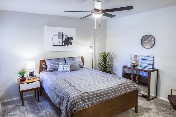 Chic bedroom with modern decor and large windows at OTTAVO Apartments, luxury living in a vibrant community