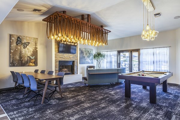 Clubhouse game room with billiards and lounge seating at OTTAVO Apartments, luxury living by Greystar