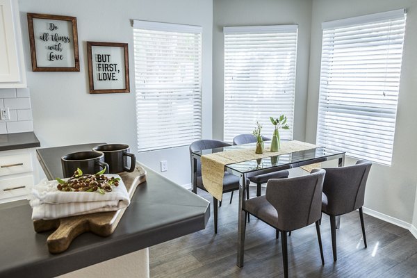 Dining room featuring modern furnishings and elegant lighting at Ottavo Apartments