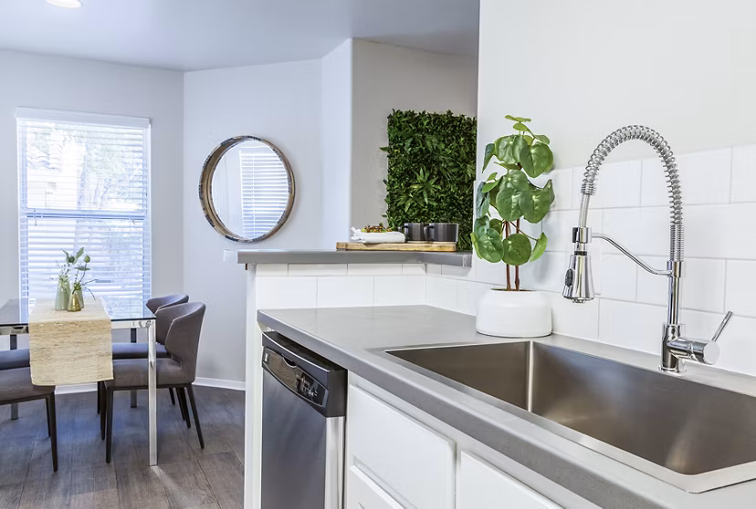 Contemporary kitchen with stainless steel appliances and marble countertops at OTTAVO Apartments