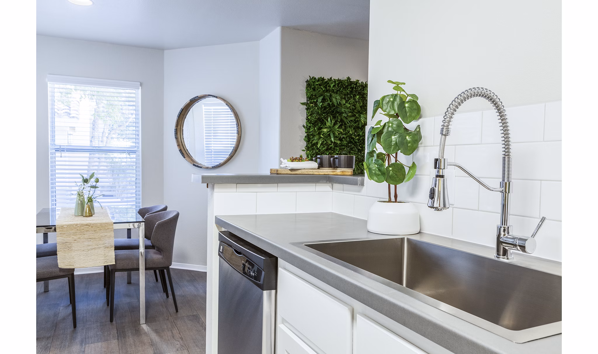 Contemporary kitchen with stainless steel appliances and marble countertops at OTTAVO Apartments