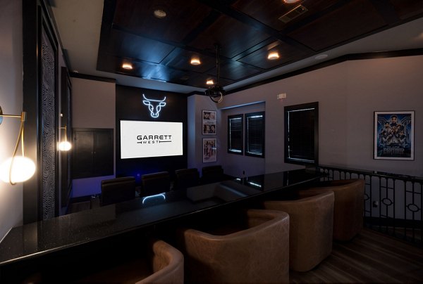 Modern theater room with plush seating at Garrett West Apartments, ideal for movie nights and entertainment