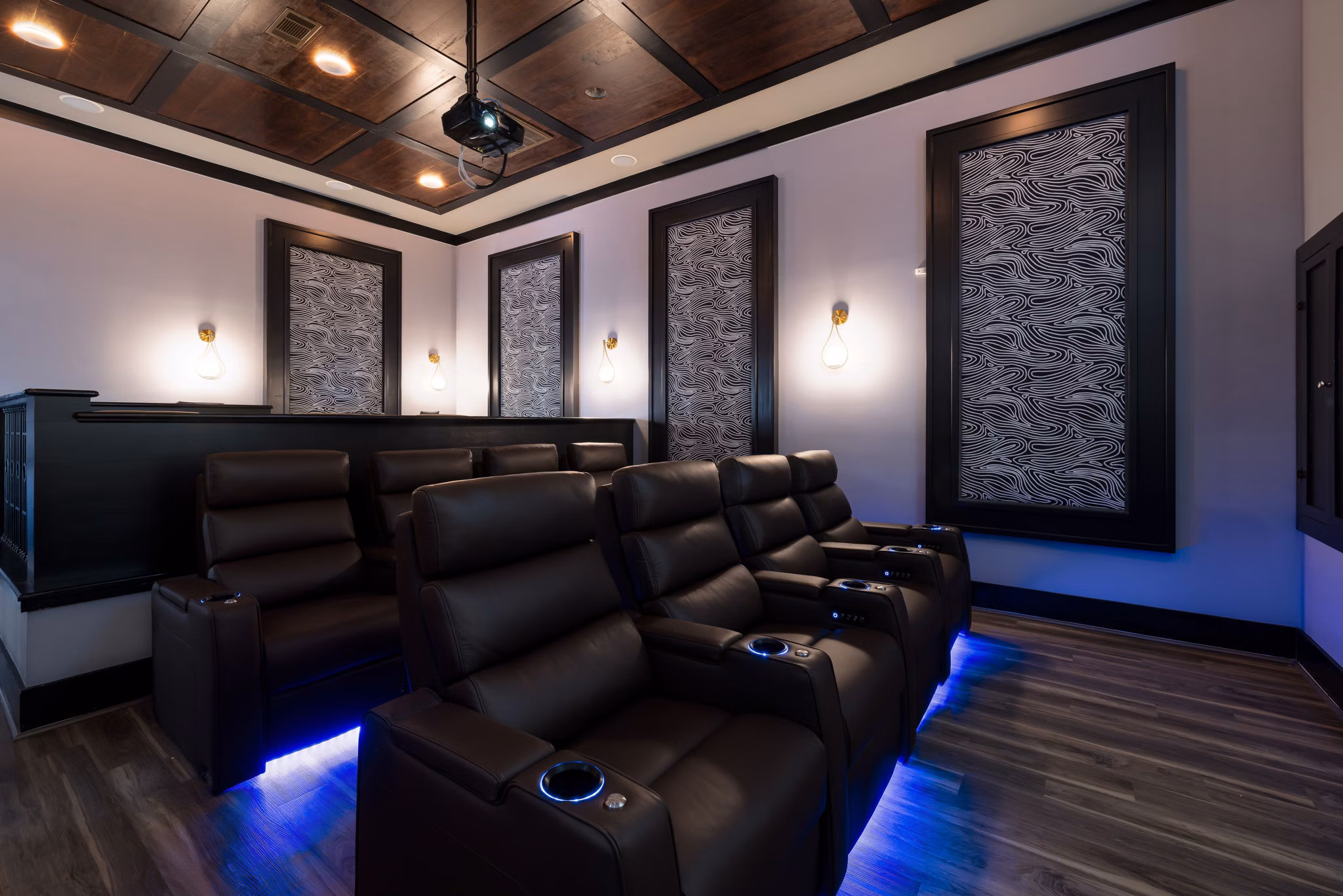 Theater room with plush seating and large screen at Garrett West Apartments