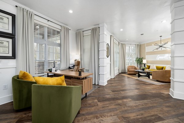 Clubhouse featuring modern design and cozy seating at Garrett West Apartments luxury living community