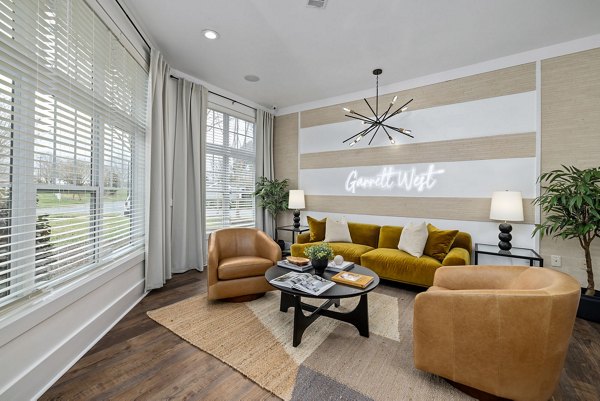 Clubhouse featuring modern design and cozy seating at Garrett West Apartments