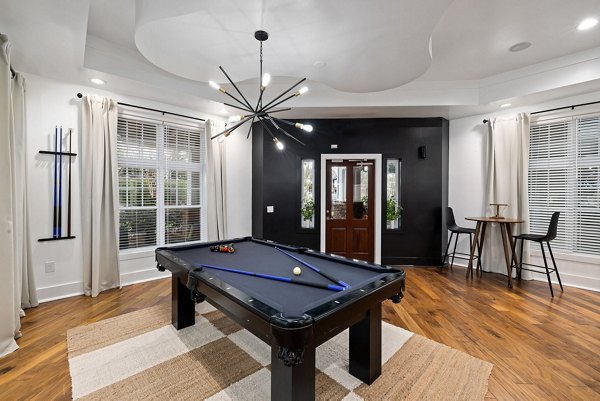 Modern clubhouse with stylish seating and pool table at Garrett West Apartments, perfect for social gatherings and relaxation