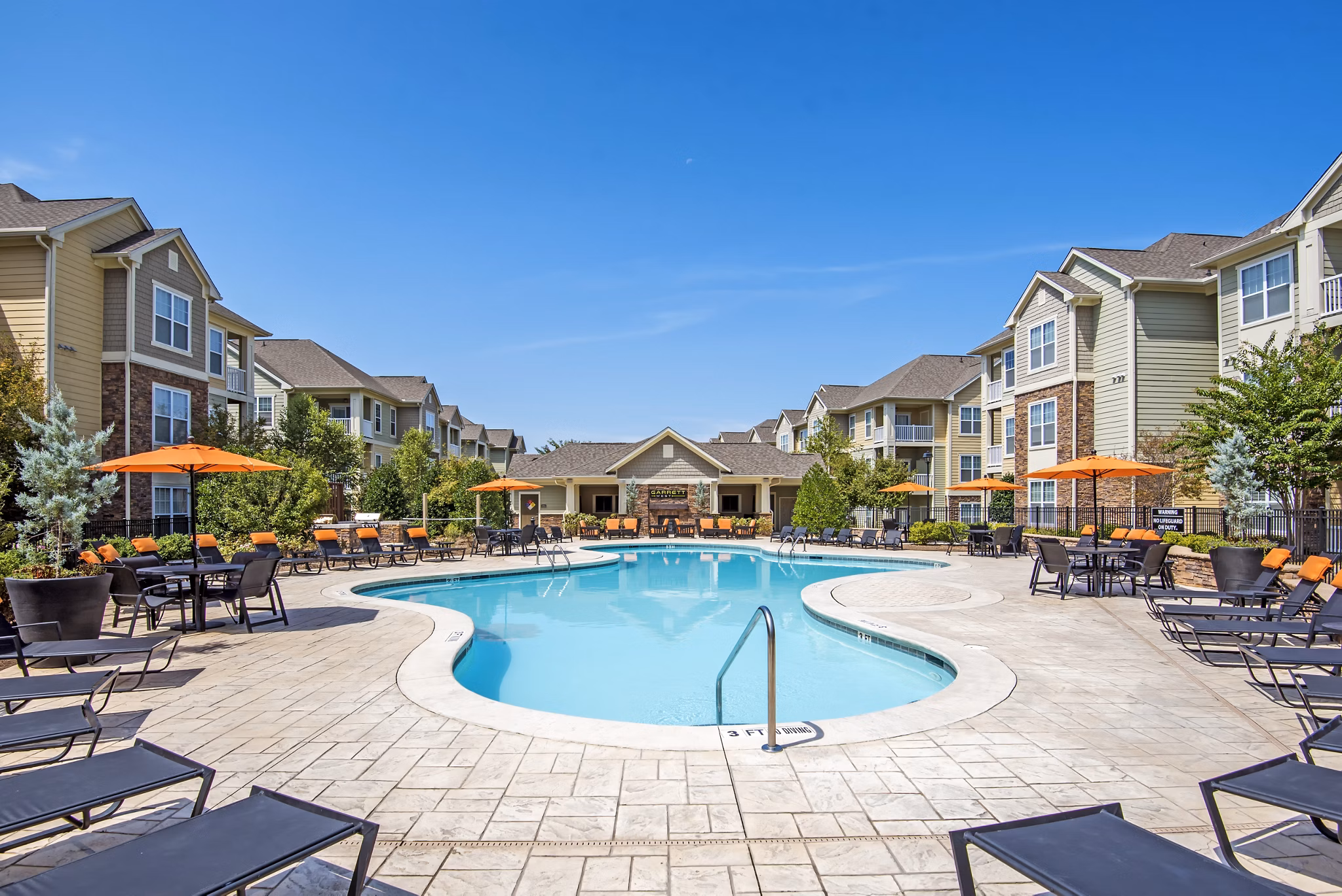 Inviting swimming pool with loungers at Garrett West Apartments