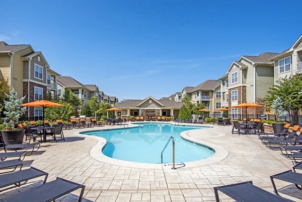 Inviting swimming pool with loungers at Garrett West Apartments