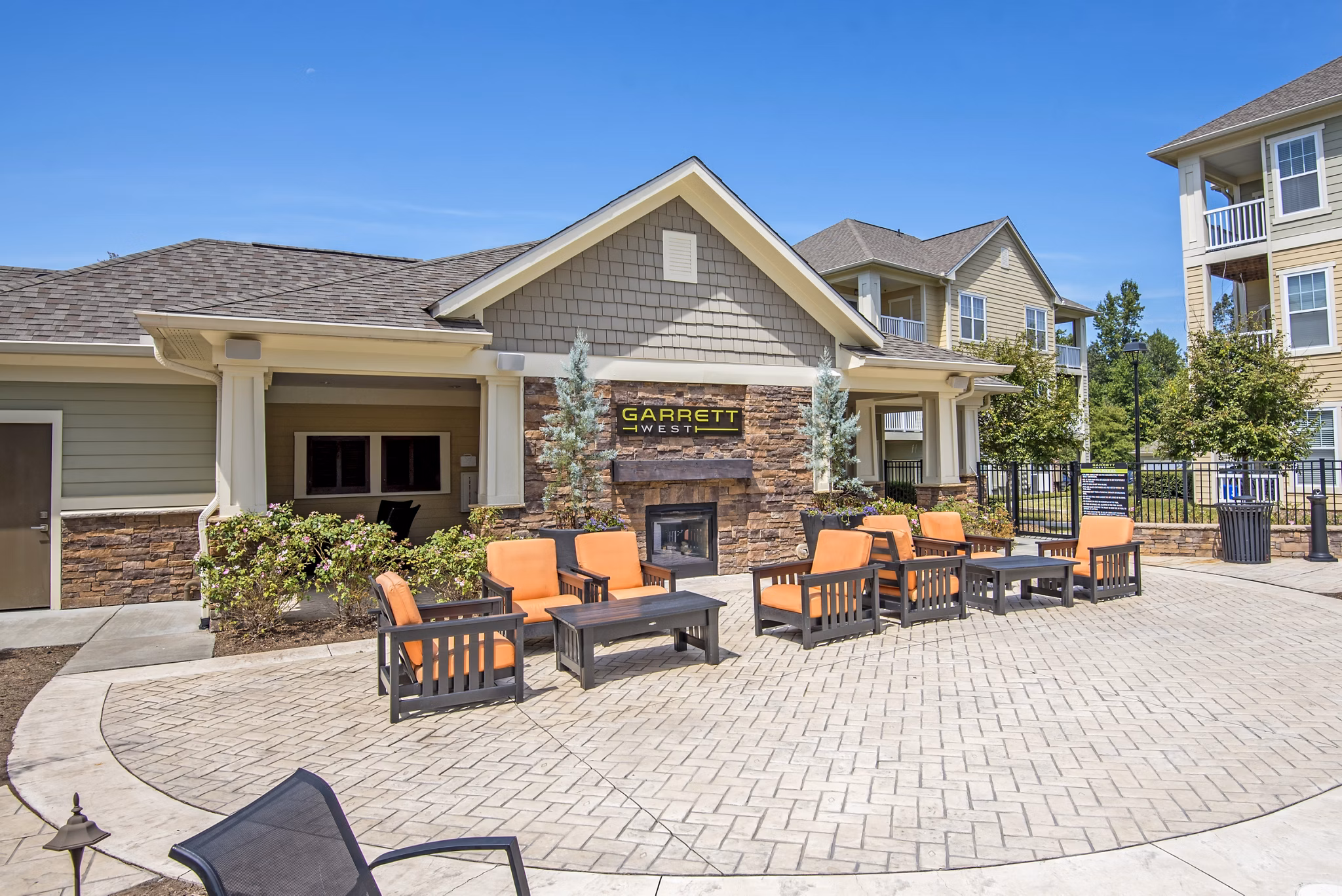 Outdoor fire pit with cozy seating at Garrett West Apartments, ideal for social gatherings and relaxation
