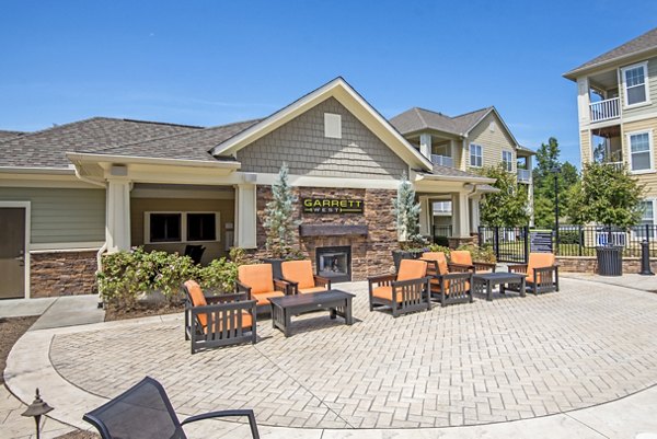 Outdoor fire pit with cozy seating at Garrett West Apartments, ideal for social gatherings and relaxation