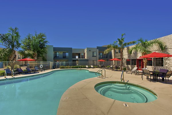 Expansive pool with sun loungers at Esteban Park Apartments, a luxury residence by Greystar