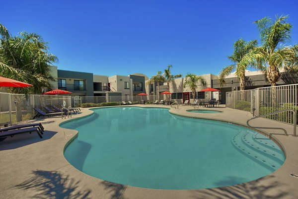 Relaxing pool area with lounge chairs at Esteban Park Apartments, a Greystar luxury community