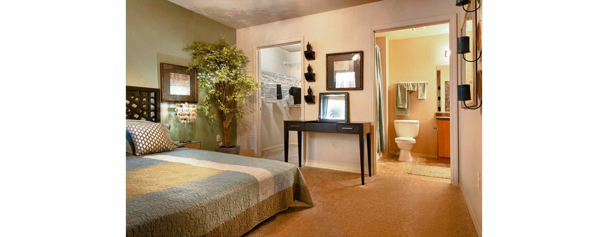 Modern bedroom with elegant decor at Esteban Park Apartments featuring luxurious bedding and ample natural light