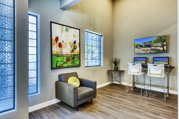 Business center with modern workstations at Esteban Park Apartments, ideal for remote work and meetings in a luxury apartment setting