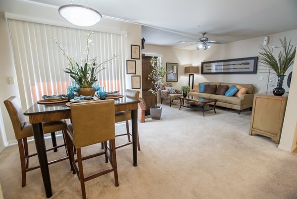 Dining room with elegant lighting and modern furnishings at Esteban Park Apartments