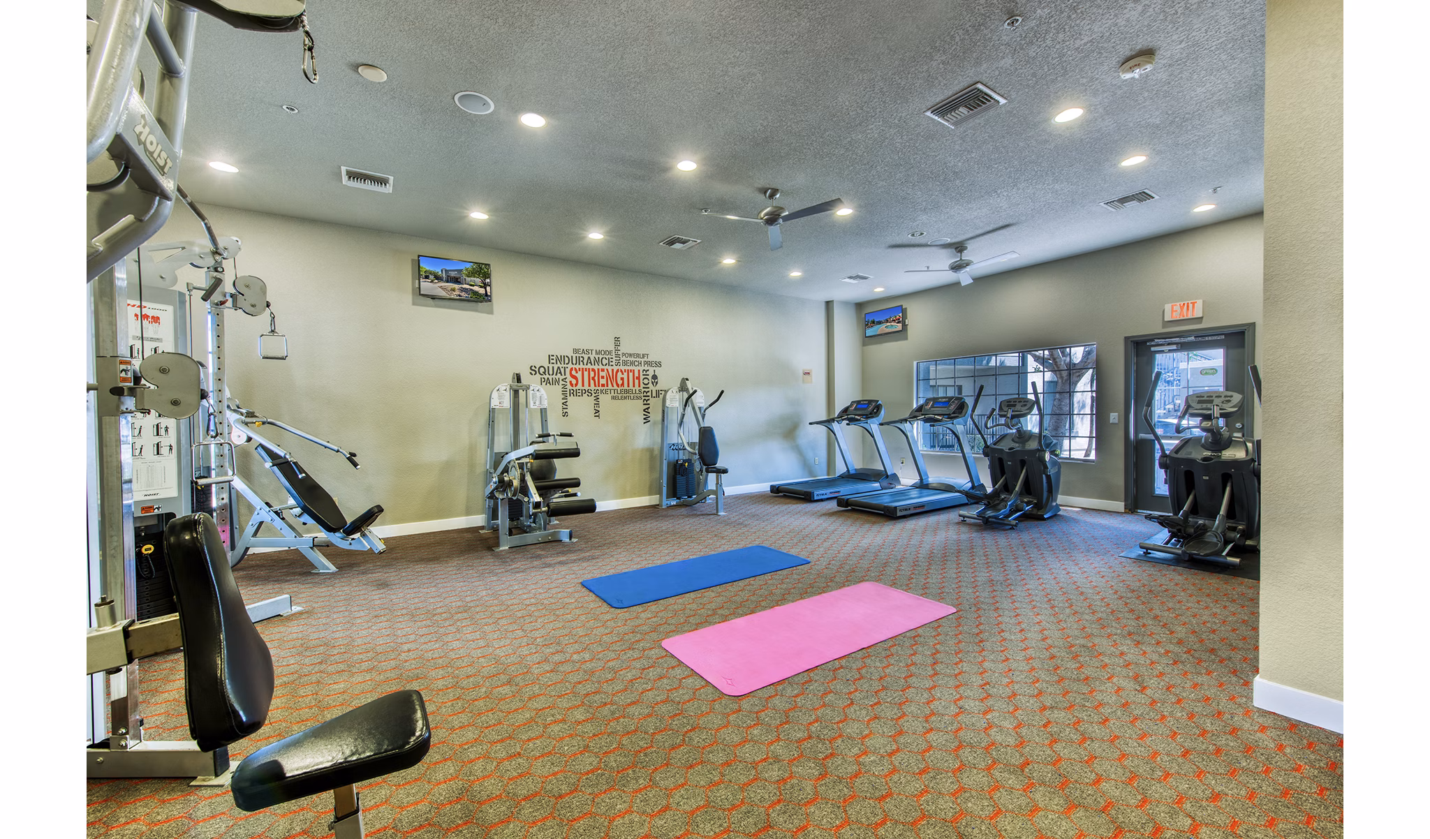 Fully-equipped fitness center with modern machines at Esteban Park Apartments for active lifestyle enthusiasts
