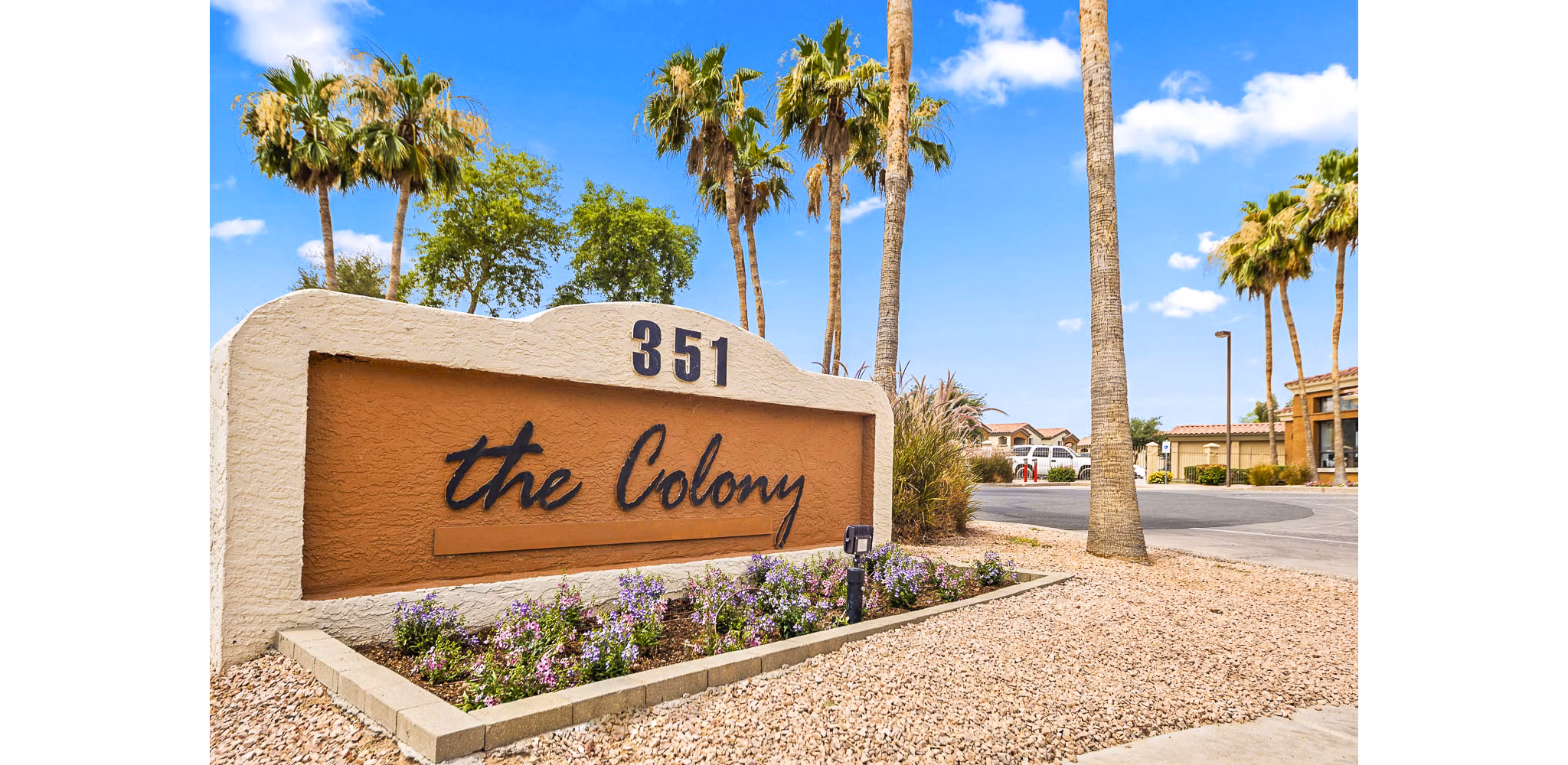 The Colony Apartments signage displaying luxury living in a serene community setting