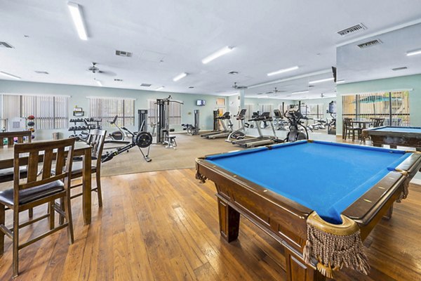 Modern fitness center and clubhouse game room at The Colony Apartments offering luxury amenities