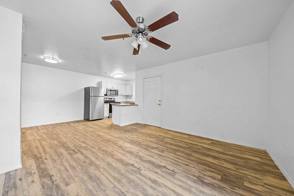 Spacious living room with modern furnishings at The Colony Apartments