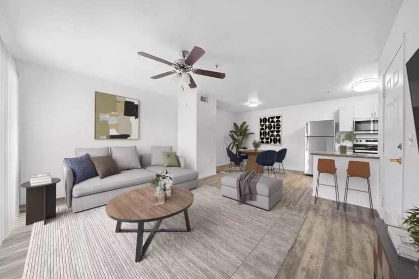 Spacious living room with modern decor at The Colony Apartments, showcasing luxury amenities and comfort