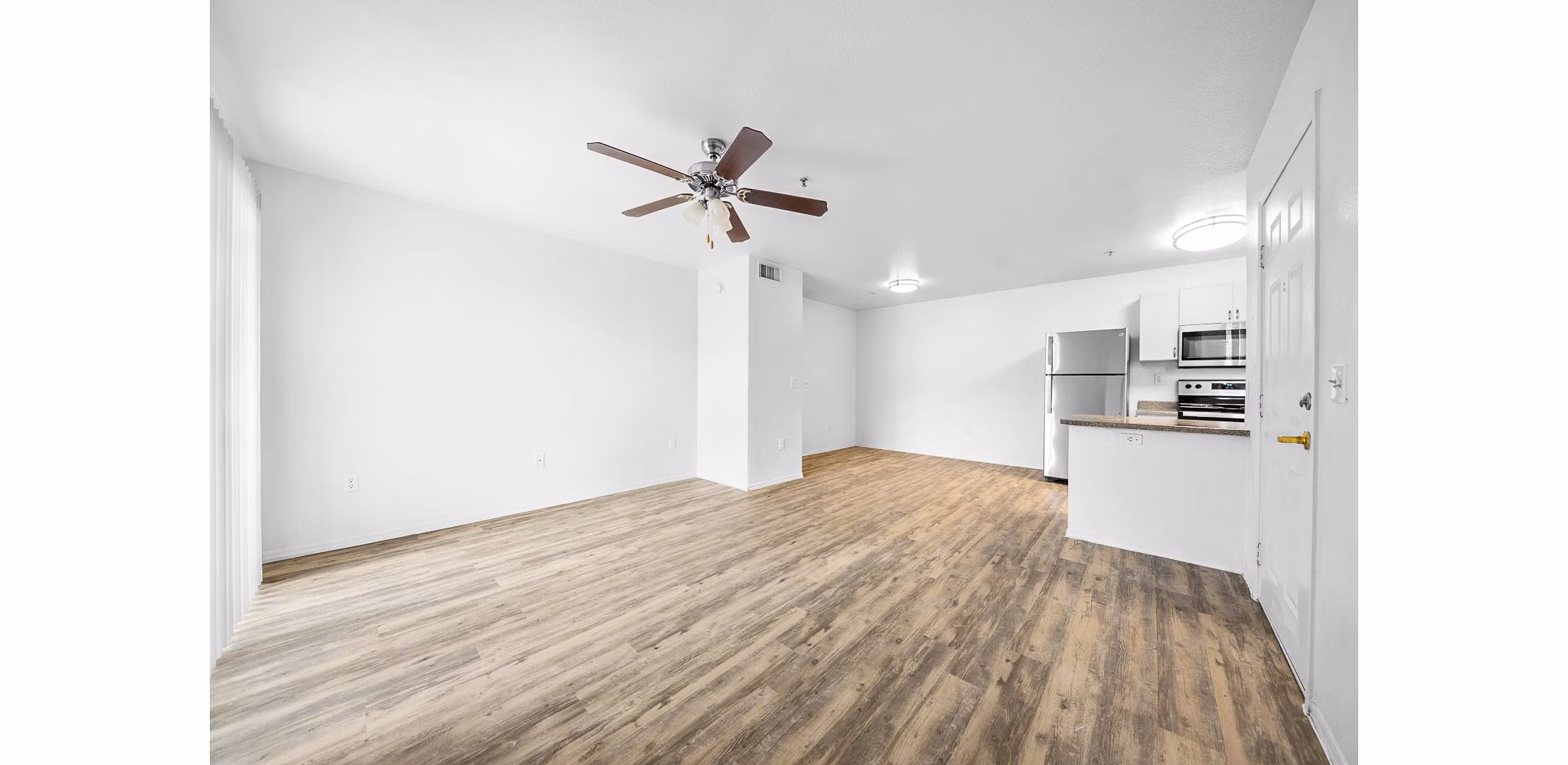 Spacious living room with modern decor at The Colony Apartments, showcasing luxury amenities and comfort