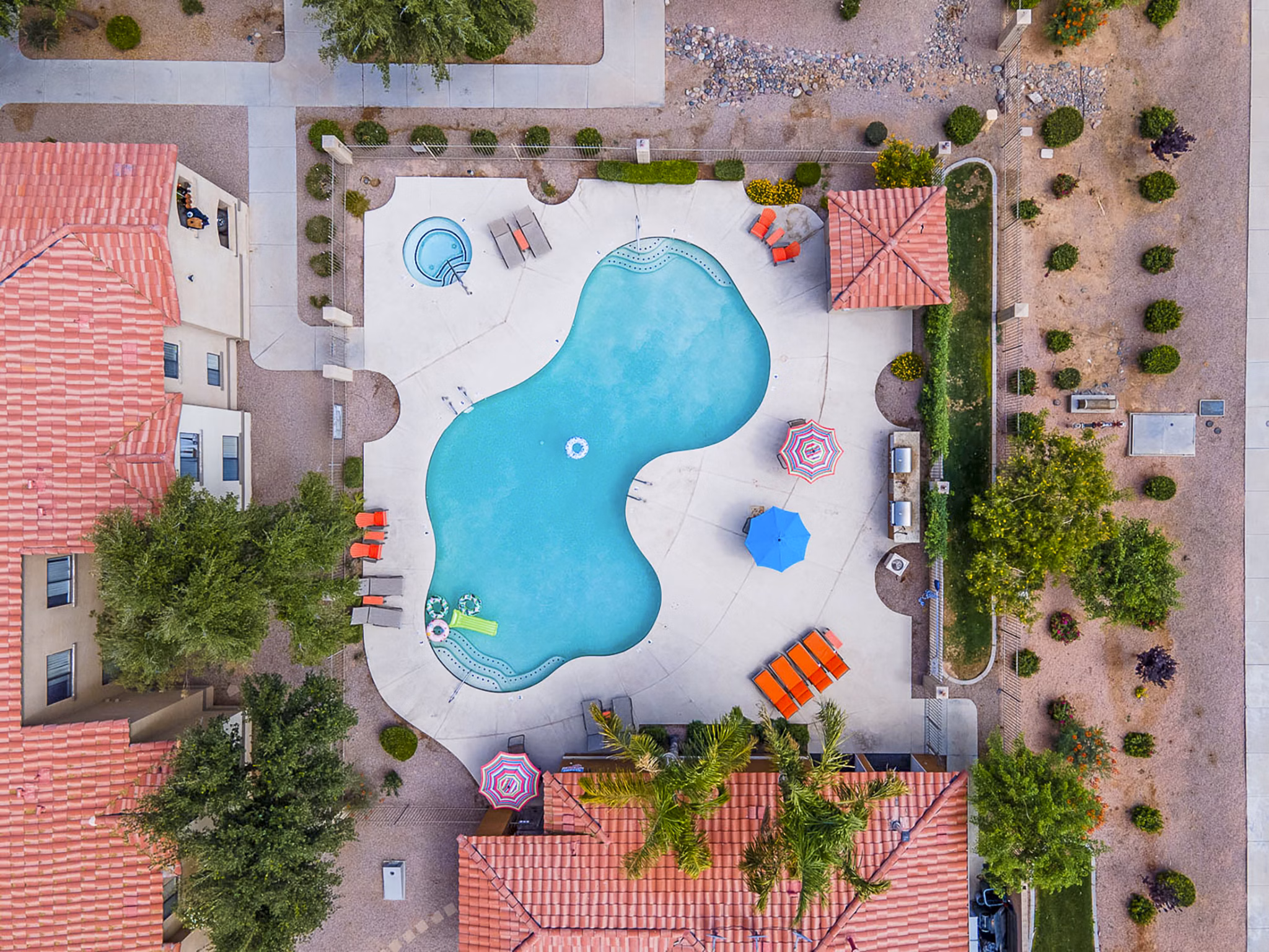 Serene outdoor pool with lounge seating at The Colony Apartments, a Greystar luxury community
