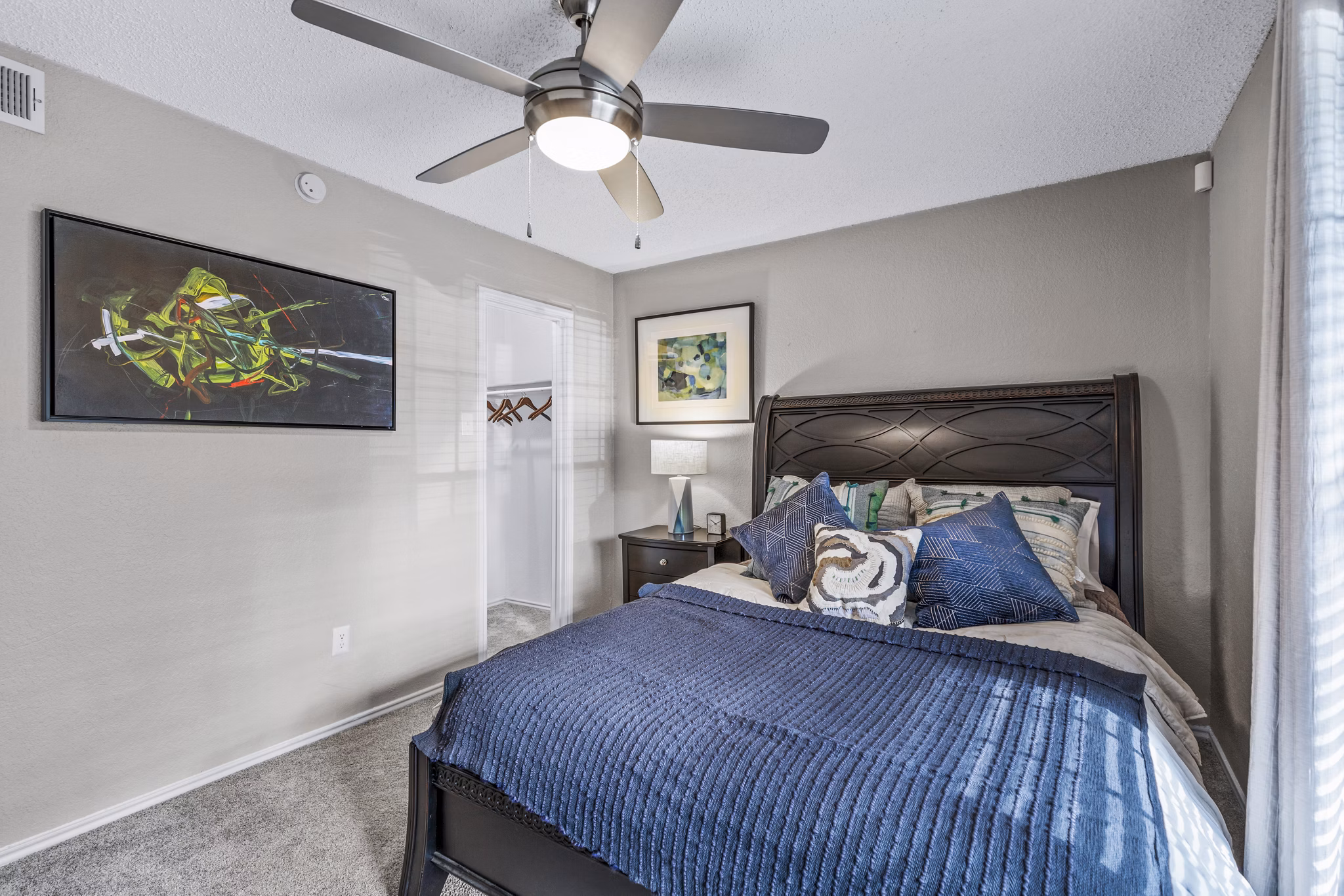 Bedroom with modern furnishings and large windows at The Georgian Apartments, offering luxury living spaces in a premier location