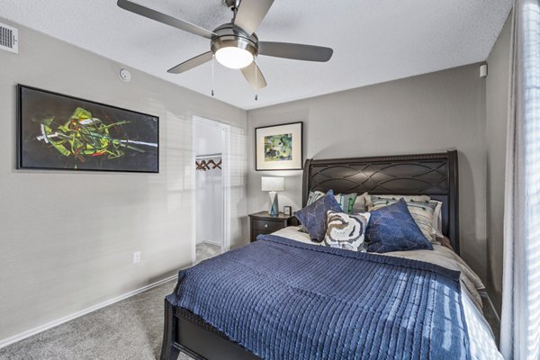 Bedroom with modern furnishings and large windows at The Georgian Apartments, offering luxury living spaces in a premier location