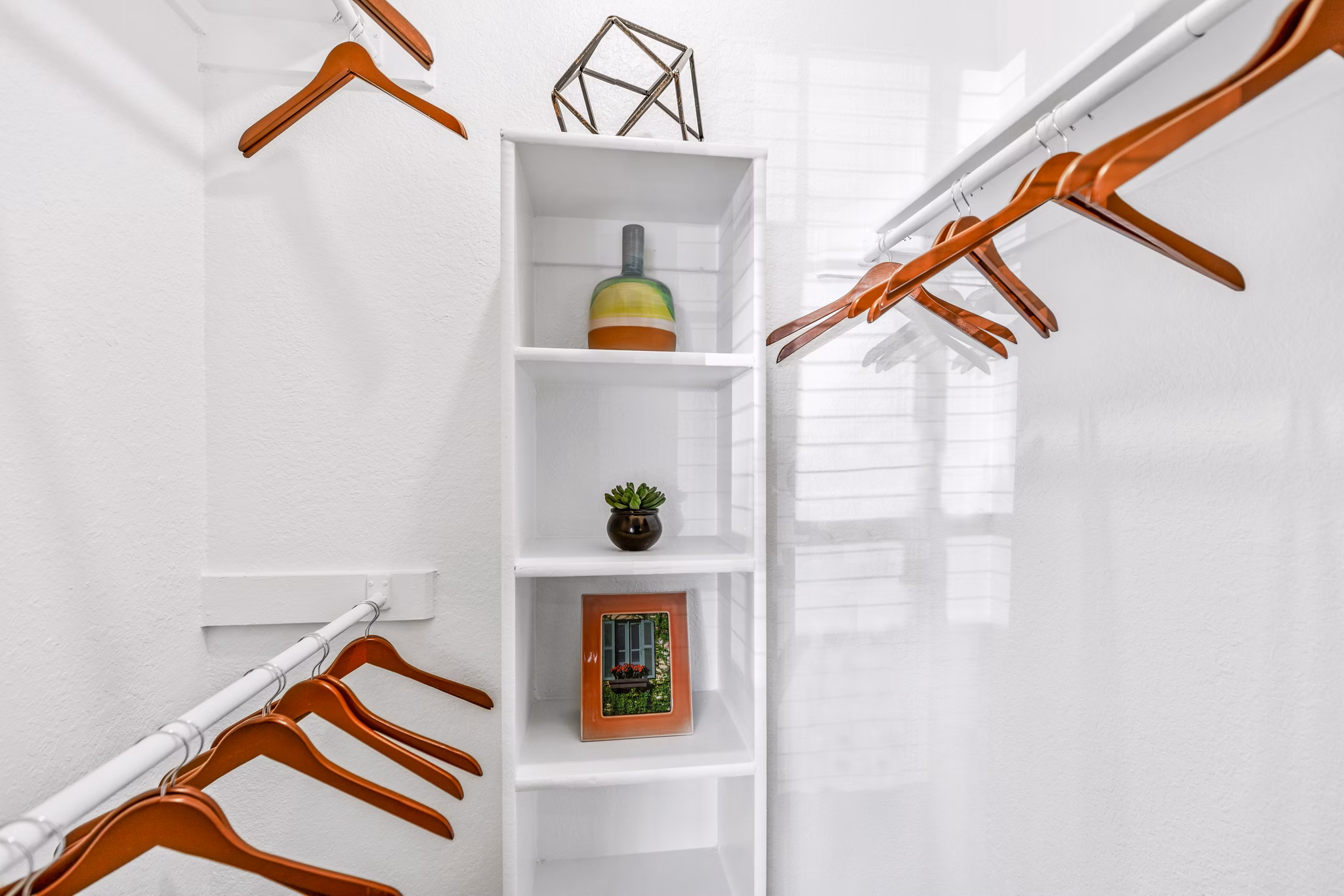 Organized bedroom closet with built-in shelving at The Georgian Apartments