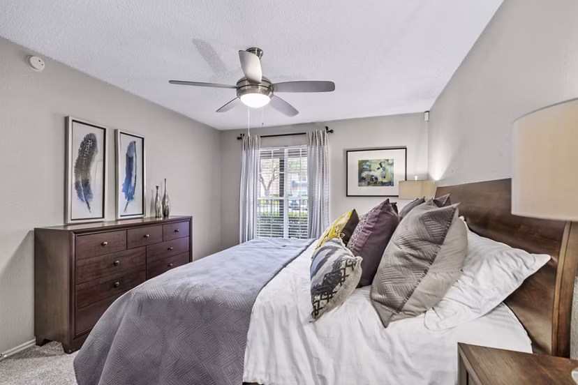Bedroom with elegant decor and large windows in The Georgian Apartments, a luxury property by Greystar in an upscale neighborhood