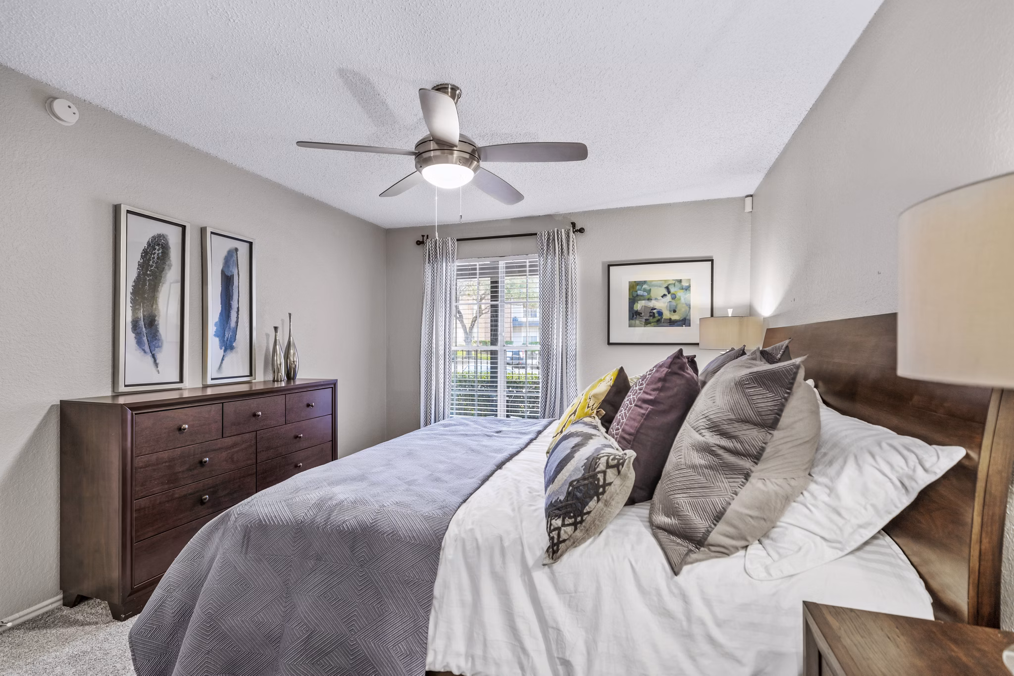 Bedroom with elegant decor and large windows in The Georgian Apartments, a luxury property by Greystar in an upscale neighborhood
