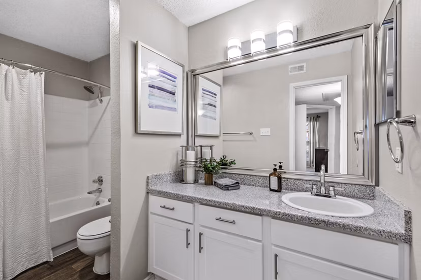 Luxurious bathroom featuring marble countertops and modern fixtures in The Georgian Apartments