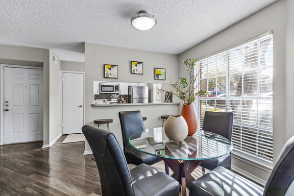 Dining room featuring elegant furniture and modern lighting at The Georgian Apartments, a luxury Greystar property